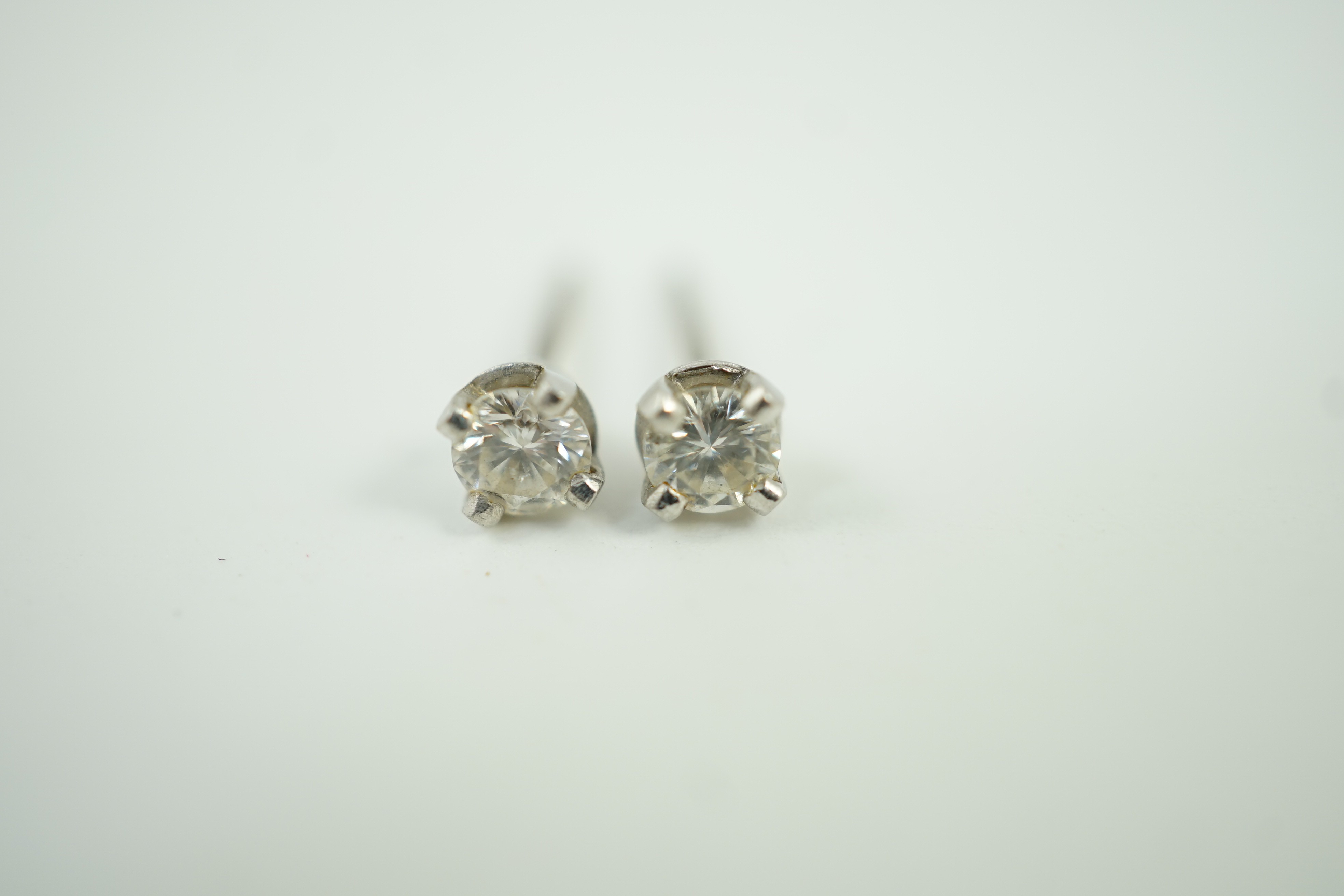 A pair of 9ct white metal and solitaire diamond ear studs, stone diameter approx. 3.4mm, gross weight 0.9 grams.